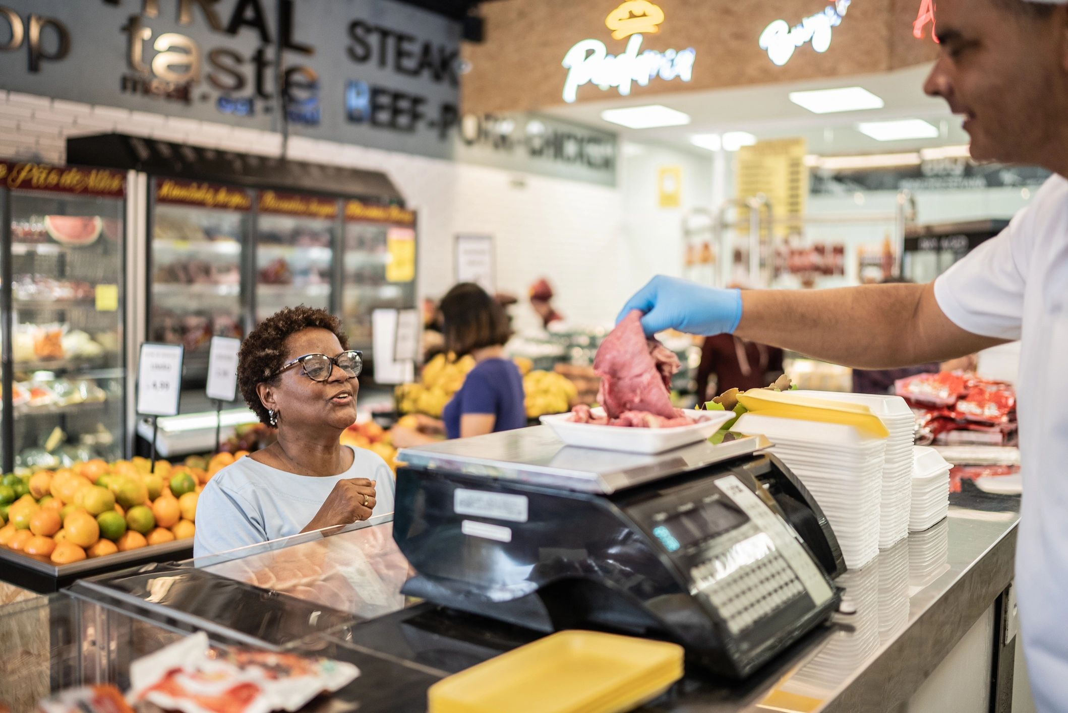 Butcher assisting a customer at the counter