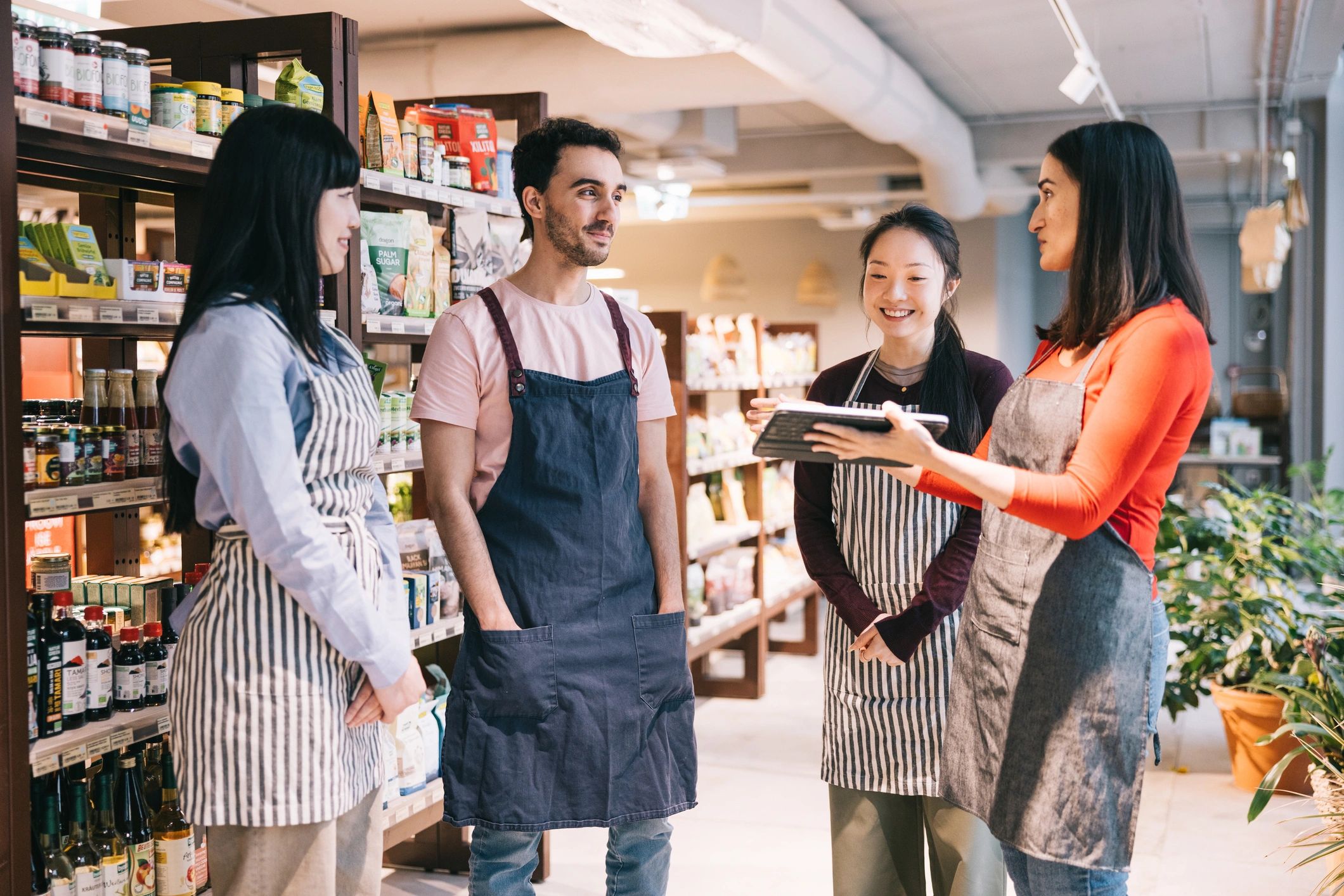 Shop manager speaking with employees in a store