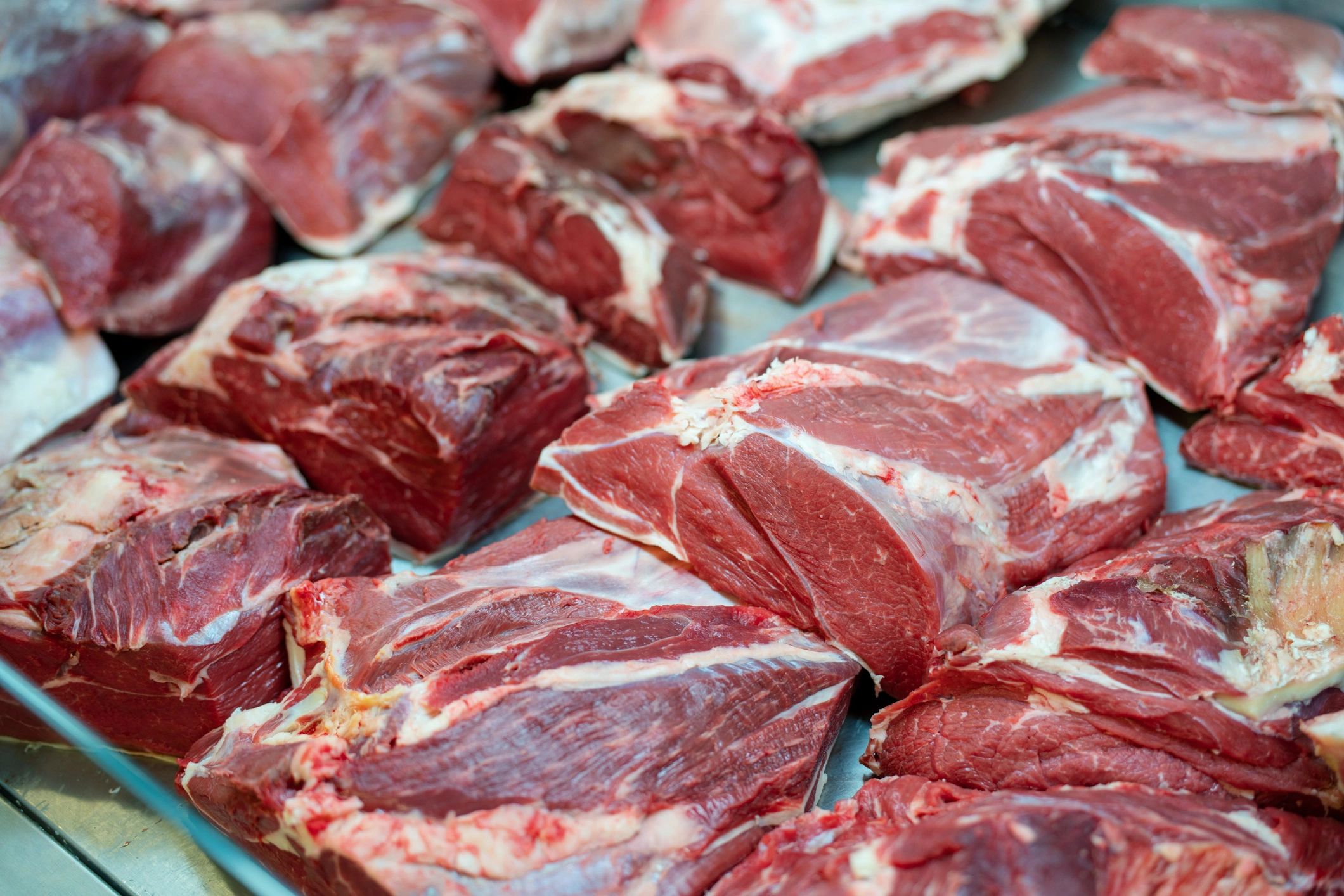 Assorted fresh meats arranged in a butcher display case