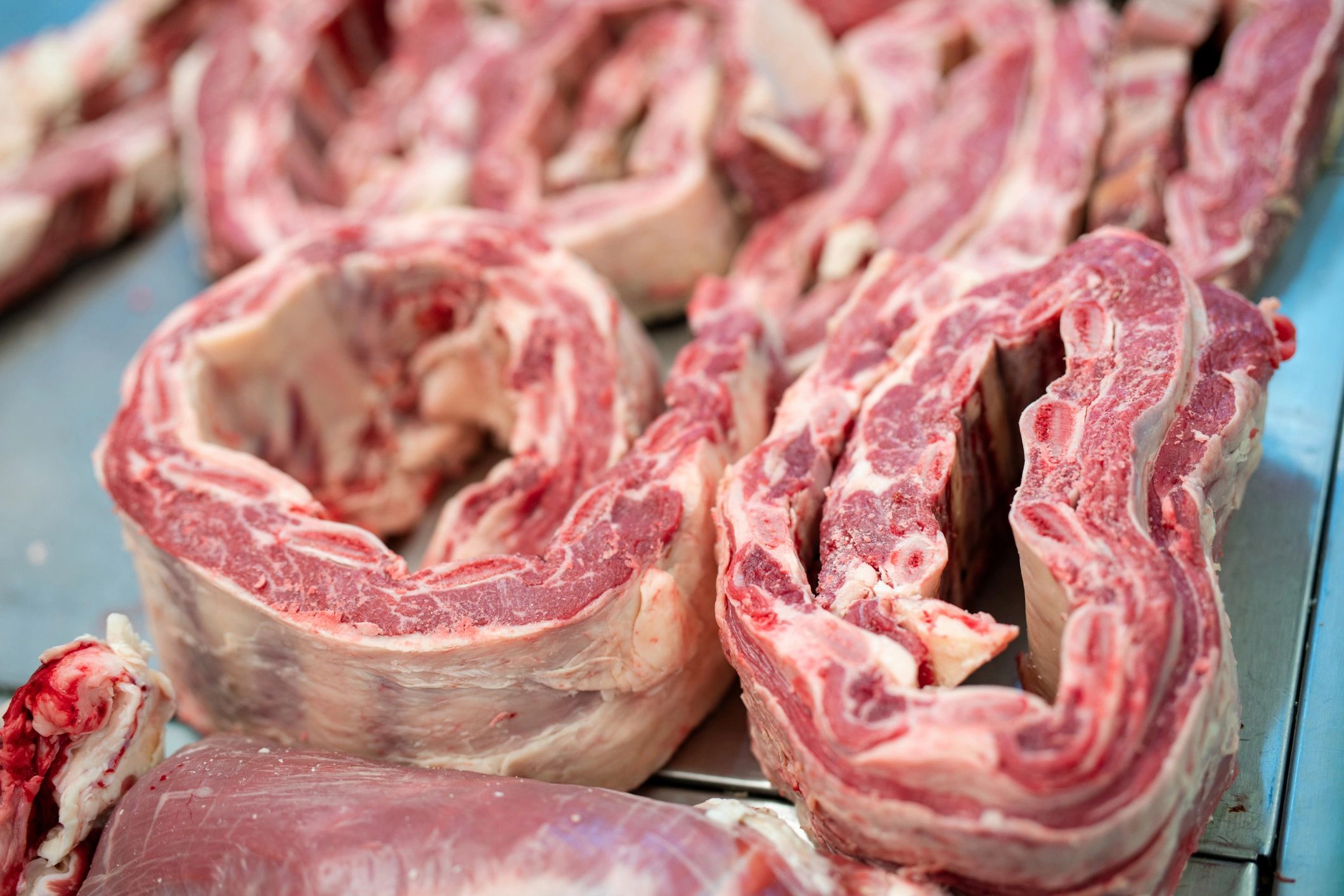 Assorted meats arranged in a butcher section display