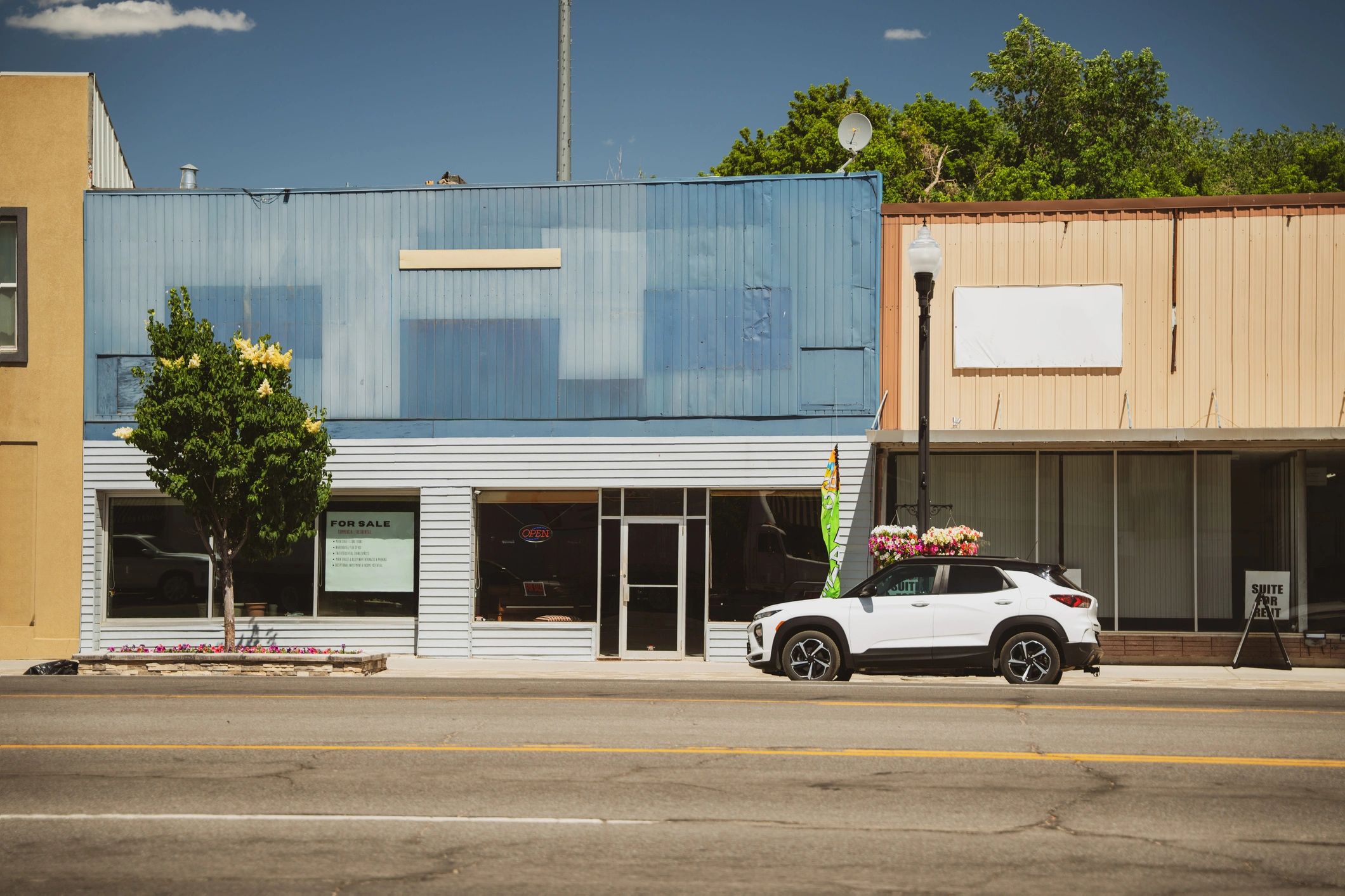 Small-town storefronts along a quiet street